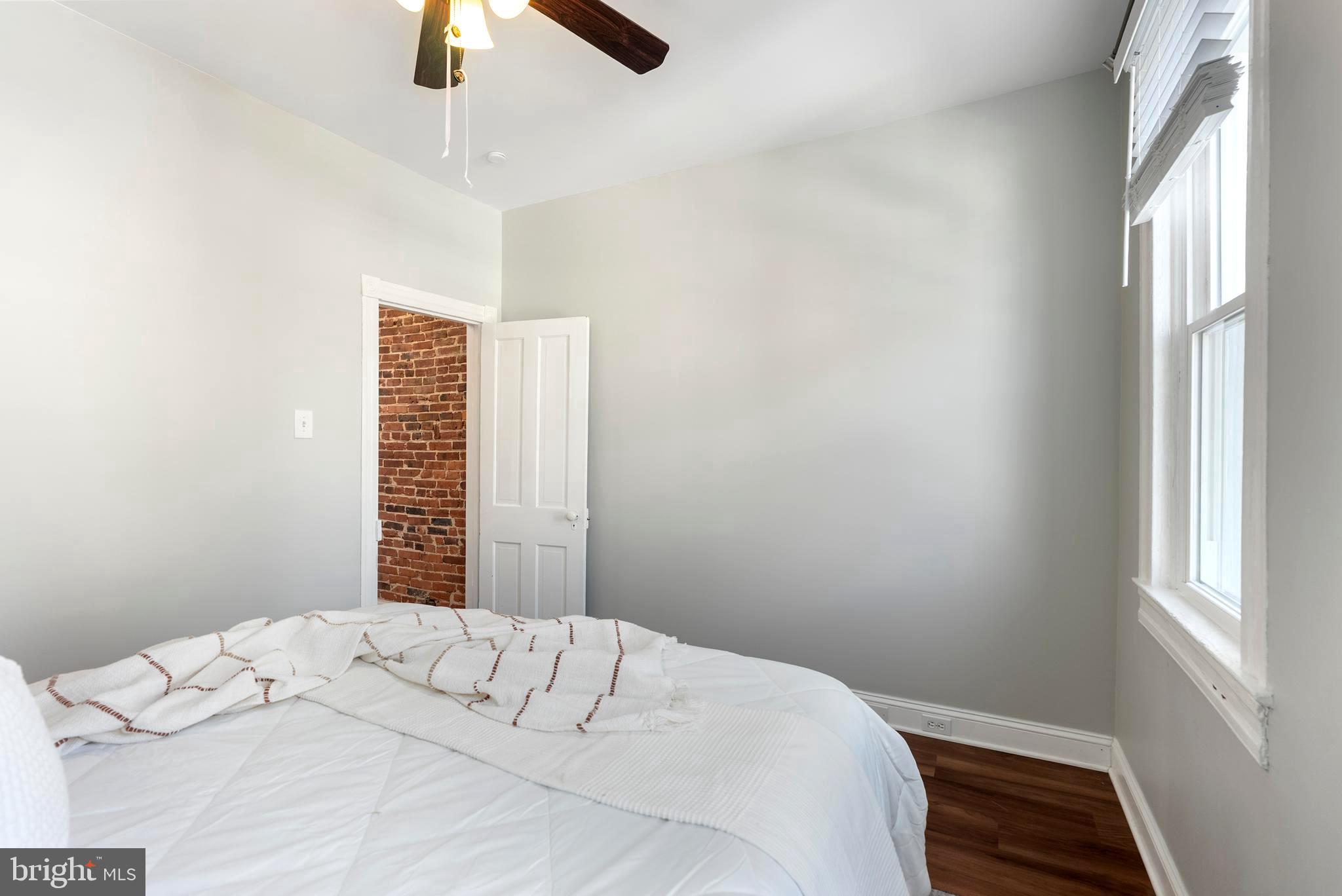 280 South Robinson Street Baltimore, MD 21224 - Photo 29 of 40 a bedroom with a bed and a window