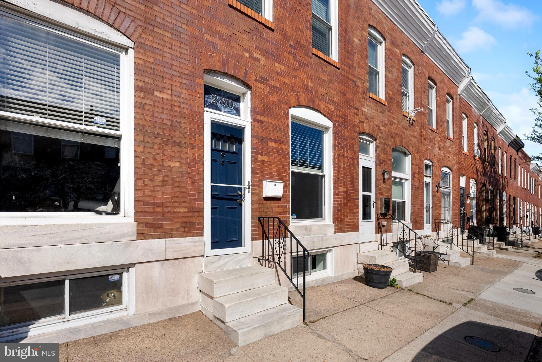 280 South Robinson Street Baltimore, MD 21224 - Photo 3 of 40 a view of a building with outdoor sitting space