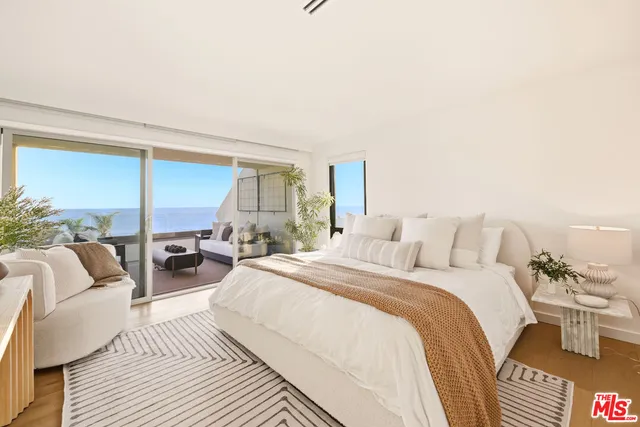 a large bedroom with a bed and large window