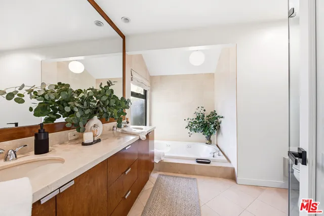 a living room with furniture and flowers