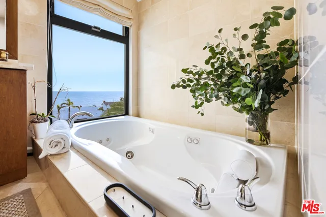 a bath tub sitting in a bathroom next to a window