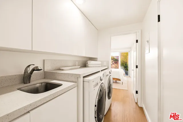 a kitchen with a sink and a washer dryer