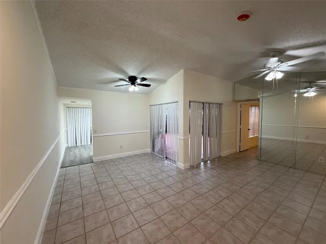 a view of a livingroom with a ceiling fan and window