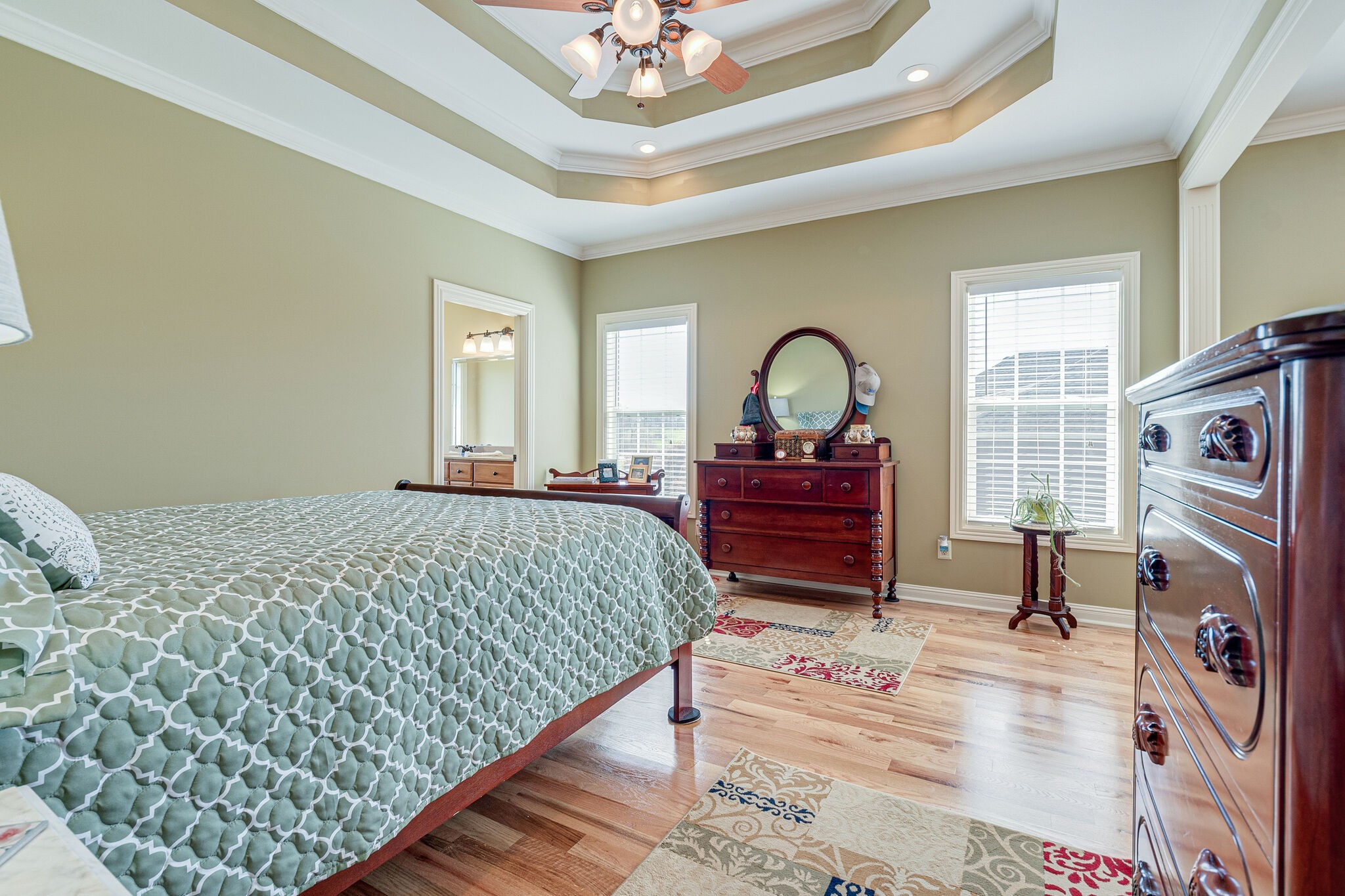 1586 Maxwell Branch Road Cottontown, TN 37048 - Photo 19 of 32 a spacious bedroom with a bed and a chandelier
