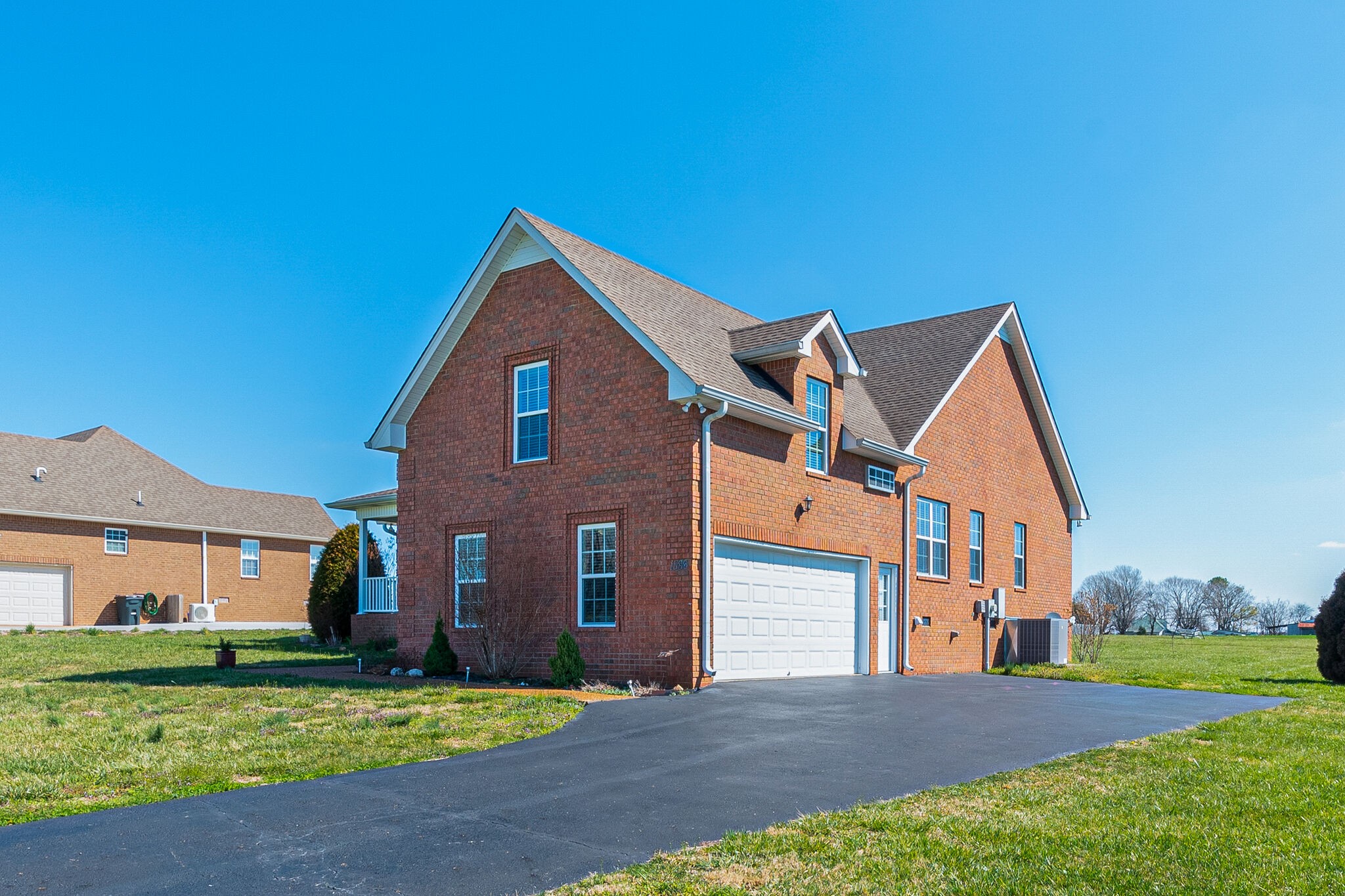 1586 Maxwell Branch Road Cottontown, TN 37048 - Photo 2 of 32 a front view of a house with a yard and garage