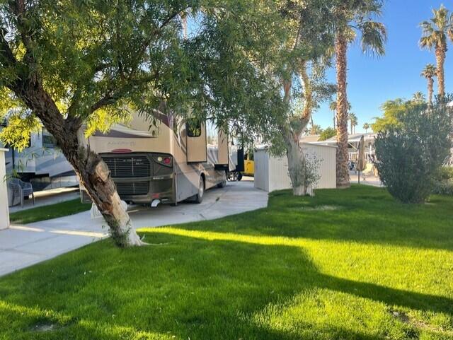 84136 Ave 44, Unit 59 Indio, CA 92203 - Photo 4 of 8 a view of a house with garden and a tree