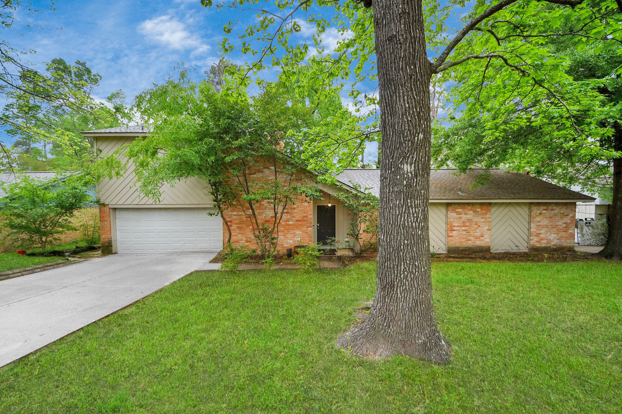 a front view of a house with a garden and yard