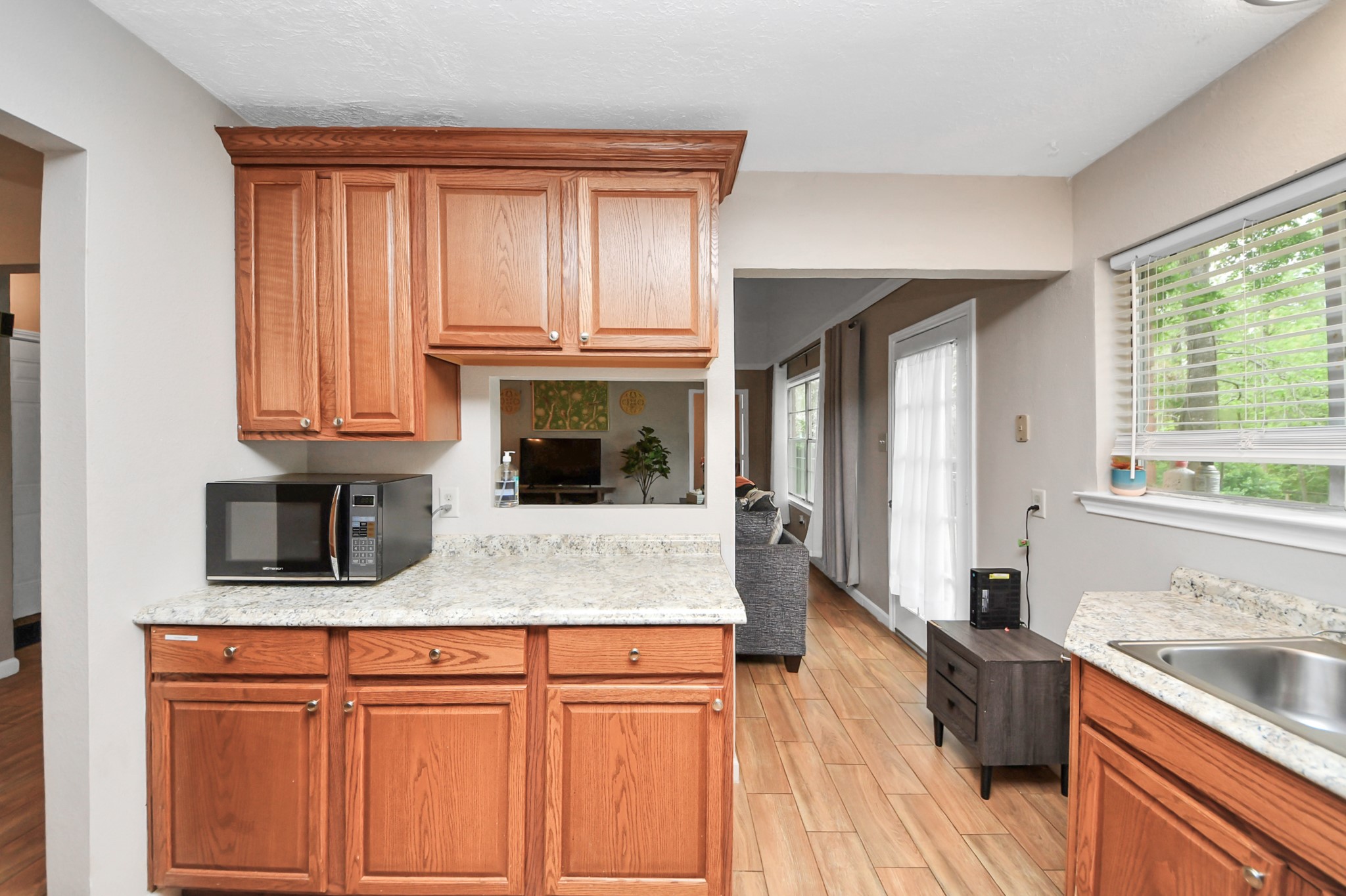 25803 Timber Lakes Drive Spring, TX 77380 - Photo 19 of 48 a kitchen with stainless steel appliances granite countertop wooden cabinets a stove a sink and a wooden floors