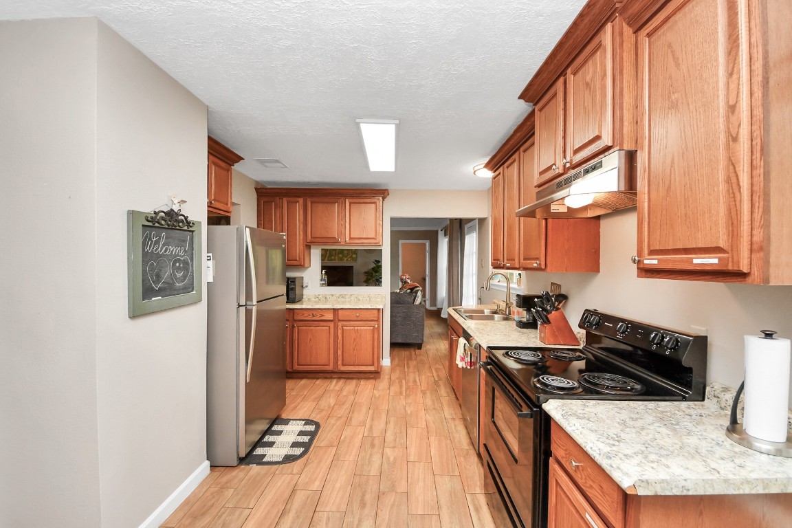 25803 Timber Lakes Drive Spring, TX 77380 - Photo 20 of 48 a kitchen with stainless steel appliances granite countertop a stove a sink dishwasher and a refrigerator