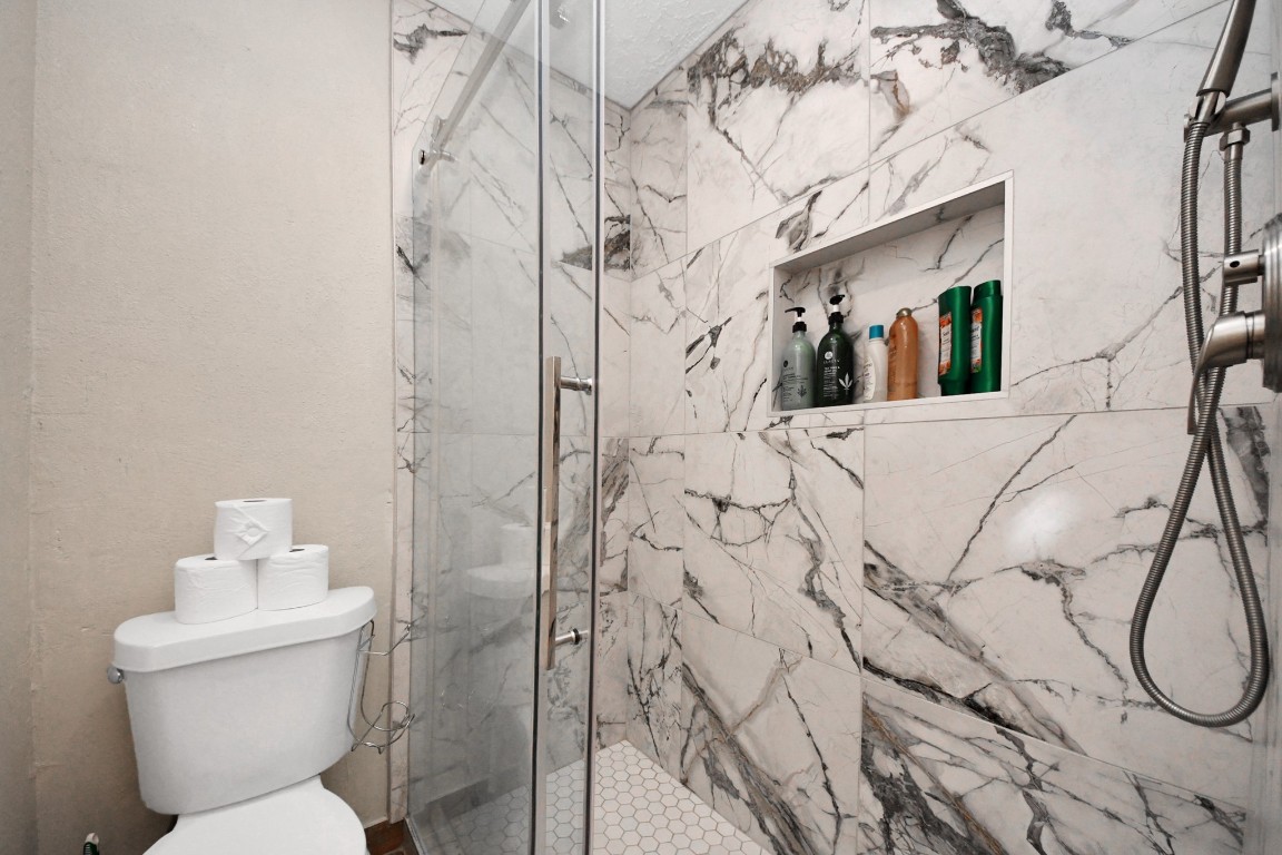 25803 Timber Lakes Drive Spring, TX 77380 - Photo 25 of 48 a bathroom with a toilet sink and shower