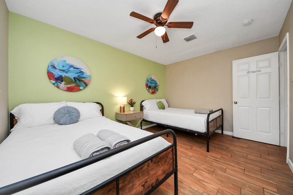 25803 Timber Lakes Drive Spring, TX 77380 - Photo 28 of 48 a bedroom with a bed and a chandelier