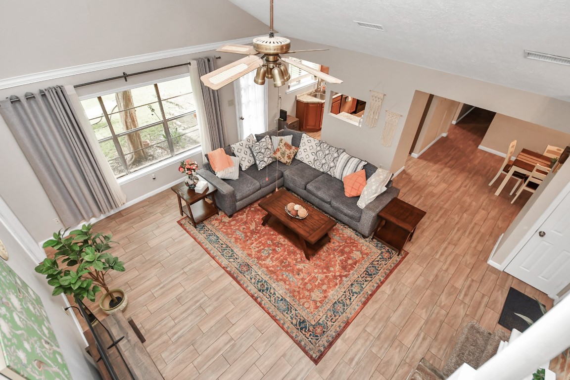 25803 Timber Lakes Drive Spring, TX 77380 - Photo 30 of 48 a living room with furniture and a floor to ceiling window