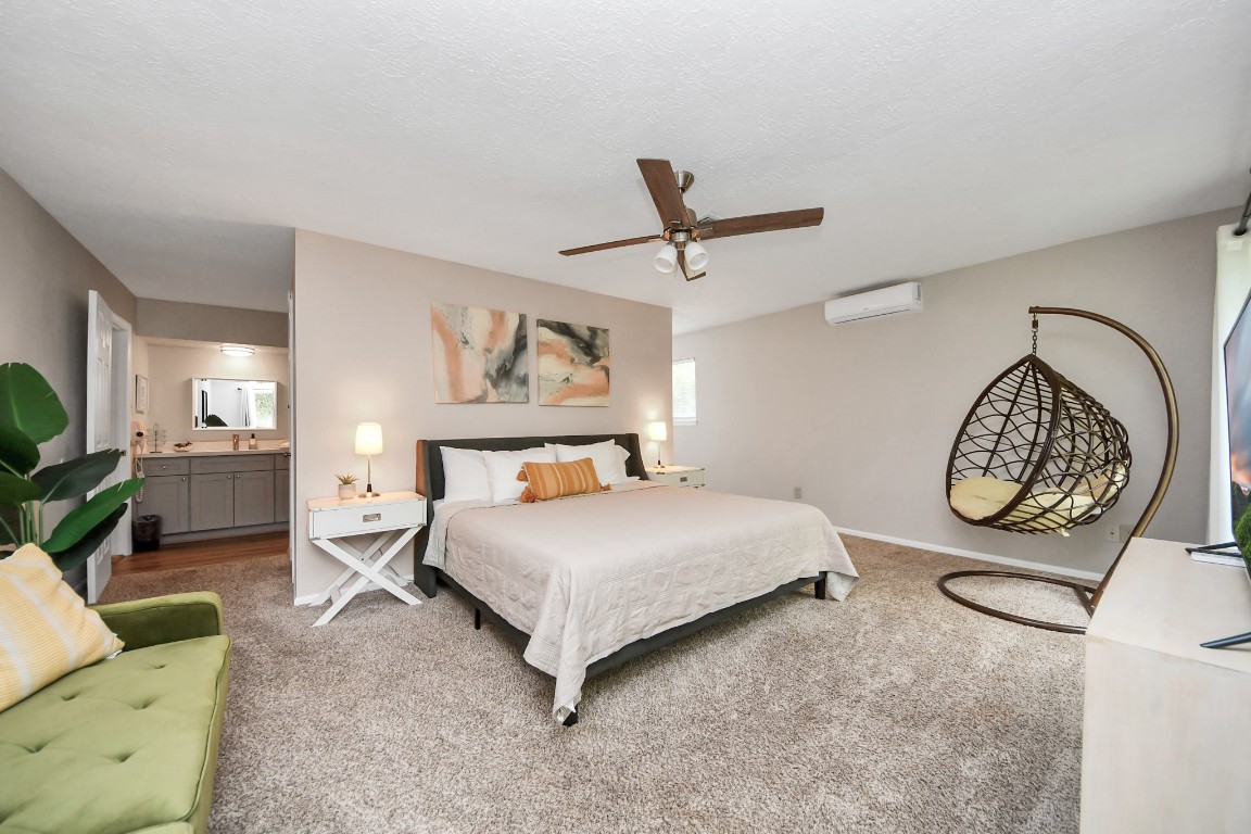 25803 Timber Lakes Drive Spring, TX 77380 - Photo 32 of 48 a bedroom with a bed a couch and dresser