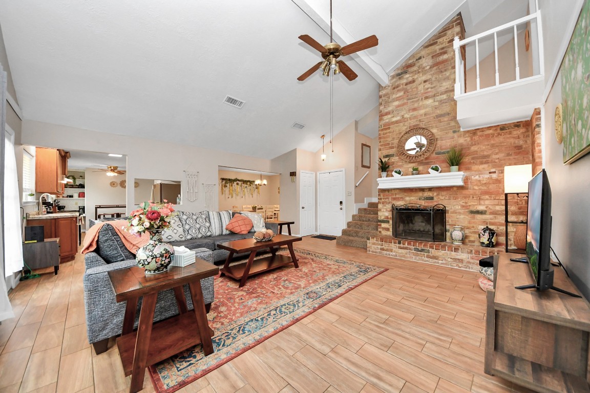 25803 Timber Lakes Drive Spring, TX 77380 - Photo 7 of 48 a living room with furniture a fireplace and a flat screen tv