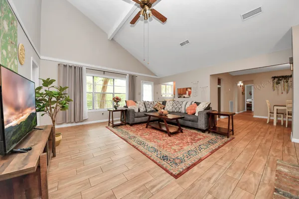 a living room with furniture and a flat screen tv