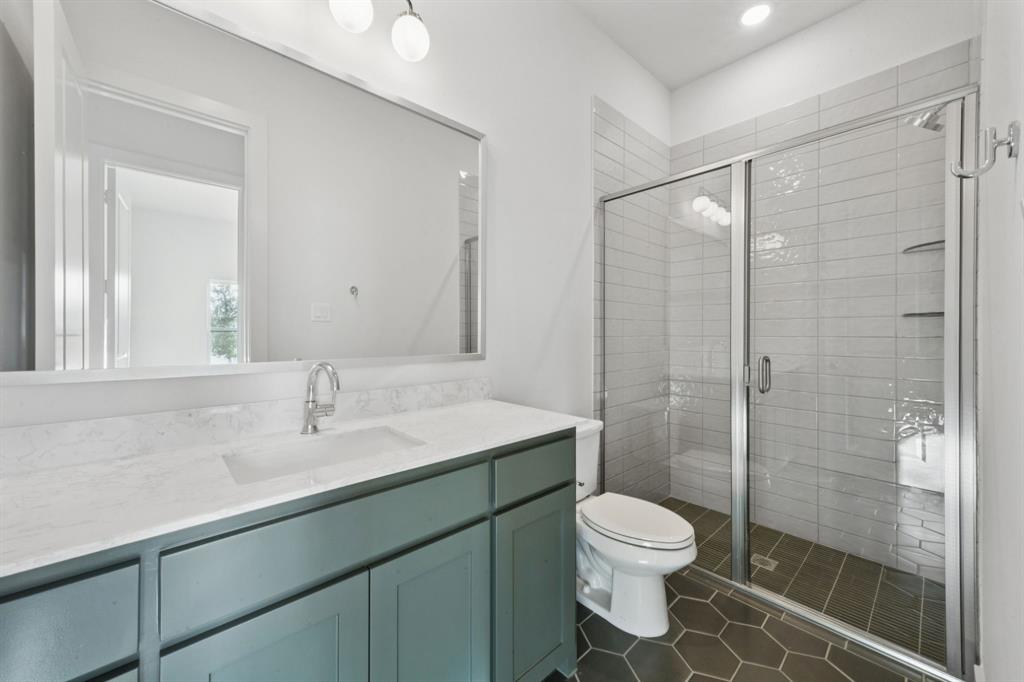 2124 Wakefield Lane Allen, TX 75013 - Photo 14 of 18 a bathroom with a toilet sink vanity granite and shower
