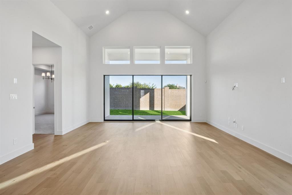 2124 Wakefield Lane Allen, TX 75013 - Photo 6 of 18 a view of an empty room with a sliding door