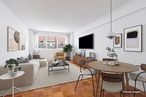 a living room with furniture a flat screen tv and a window