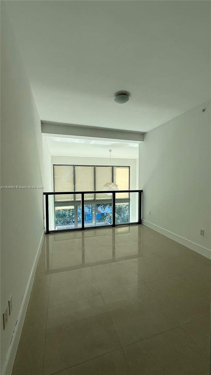 6000 Collins Avenue, Unit 323 Miami Beach, FL 33140 - Photo 18 of 35 an empty room with a empty space and windows