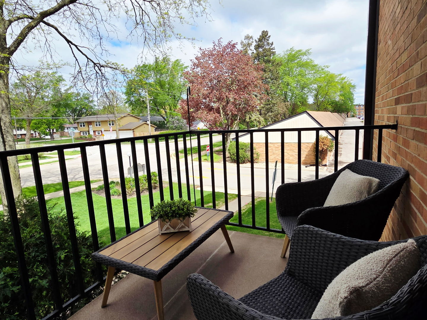 1217 South Old Wilke Road, Unit 201 Rolling Meadows, IL 60005 - Photo 7 of 26 a balcony with wooden floor and outdoor seating
