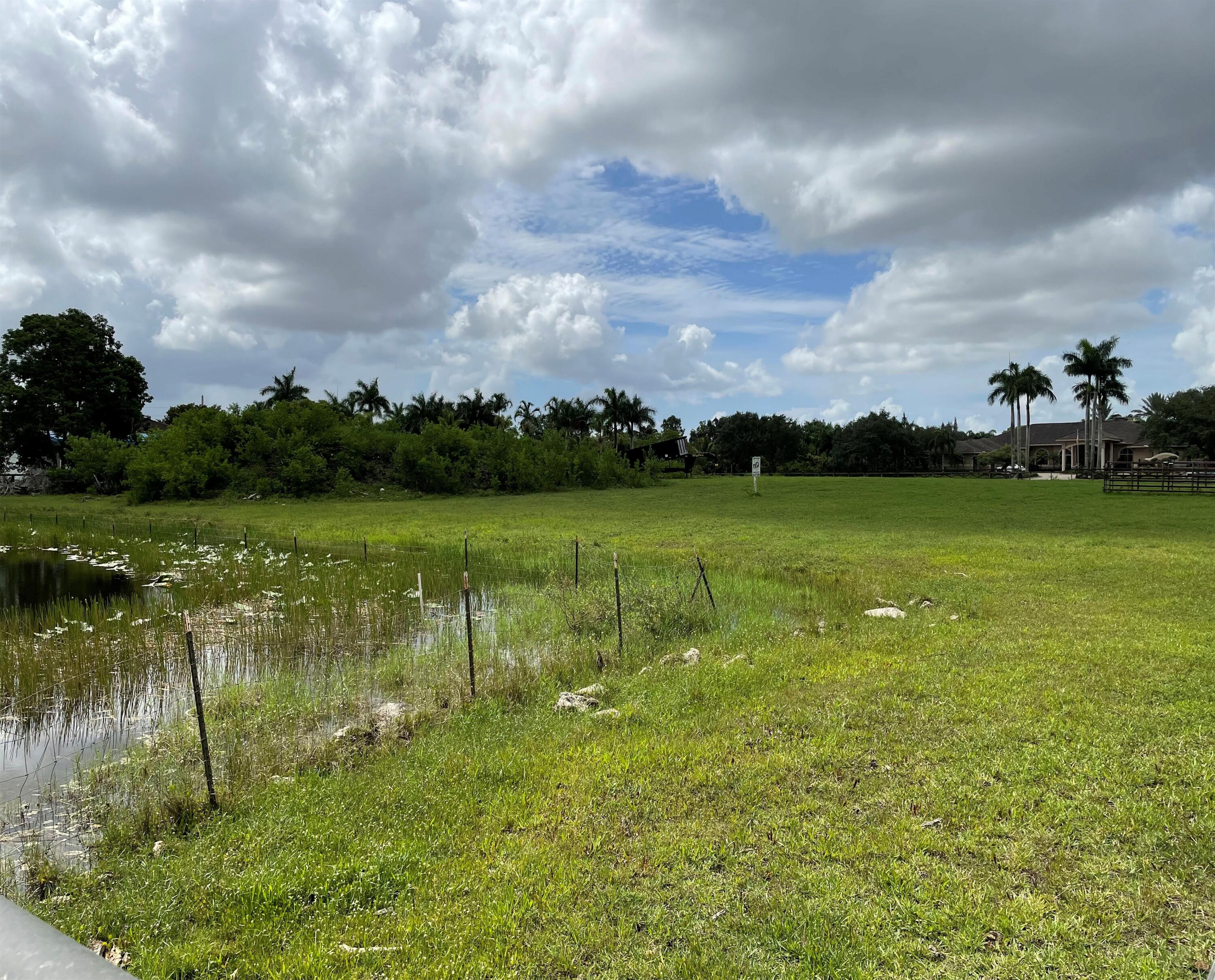 5650 Southwest 192nd Terrace Southwest Ranches, FL 33332 - Photo 2 of 29 a view of a lake with houses in the back