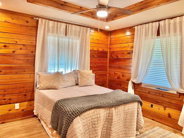 a bedroom with a large bed and a chandelier