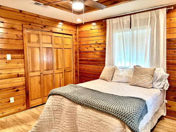 a bedroom with a large bed and a chandelier