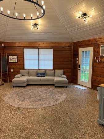 a living room with furniture and a ceiling fan