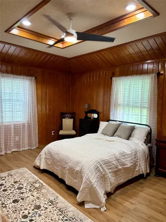 a bedroom with a bed and a large window