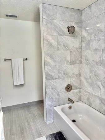 a bathroom with a bathtub and shower