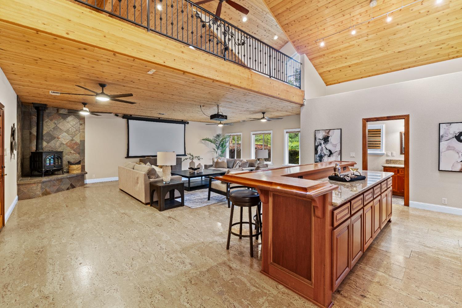 7396 Callison Road Penryn, CA 95663 - Photo 24 of 99 Great room with a 12-foot Mahogany Bar and Cabinets, and a projector with a retractable screen. The bathroom is on the right