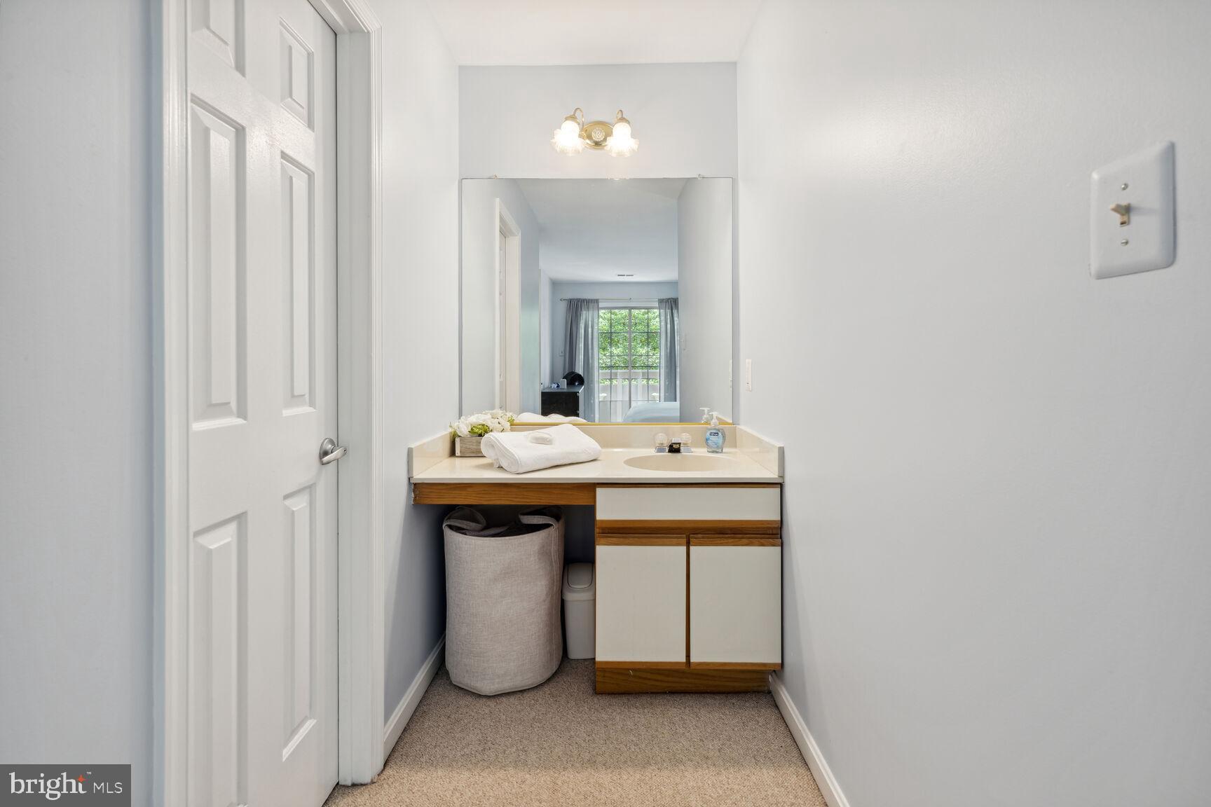 2221 Lovedale Lane, Unit 206B Reston, VA 20191 - Photo 15 of 33 PRIMARY BEDROOM vanity view 1