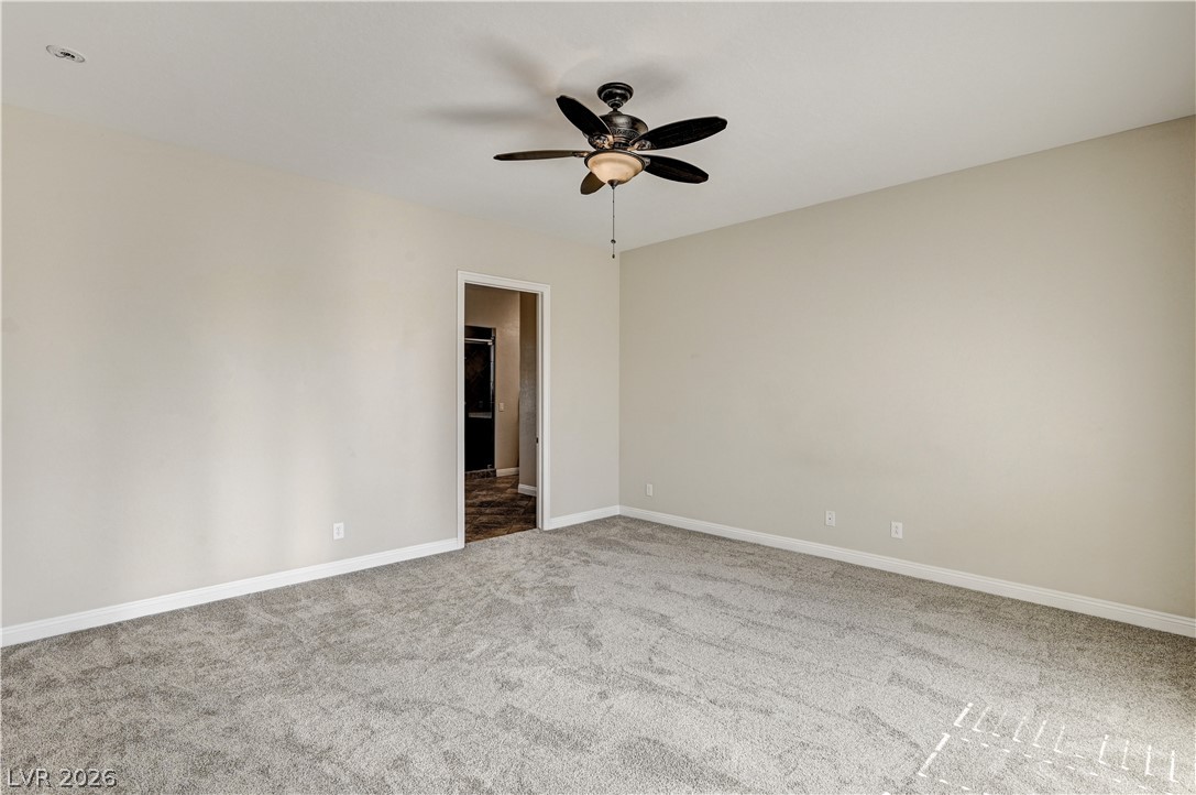 2793 Rosenhearty Drive Henderson, NV 89044 - Photo 40 of 77 A spacious and inviting room featuring soft carpet flooring and a tasteful ceiling fan fixture.