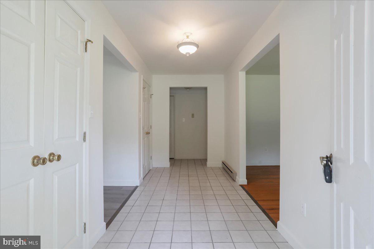 246 Poets Lane Inwood, WV 25428 - Photo 13 of 32 a view of a hallway with wooden floor and a bathroom