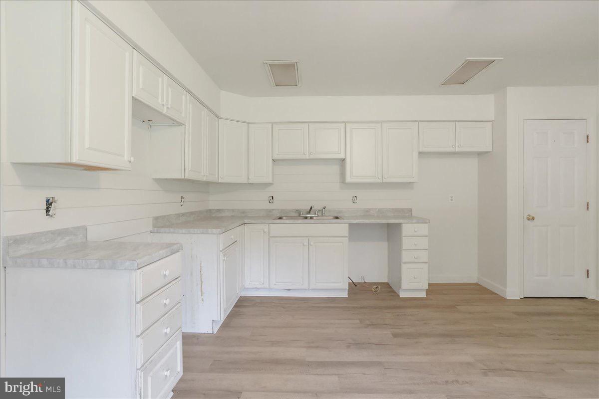 246 Poets Lane Inwood, WV 25428 - Photo 14 of 32 a kitchen with granite countertop white cabinets and white appliances