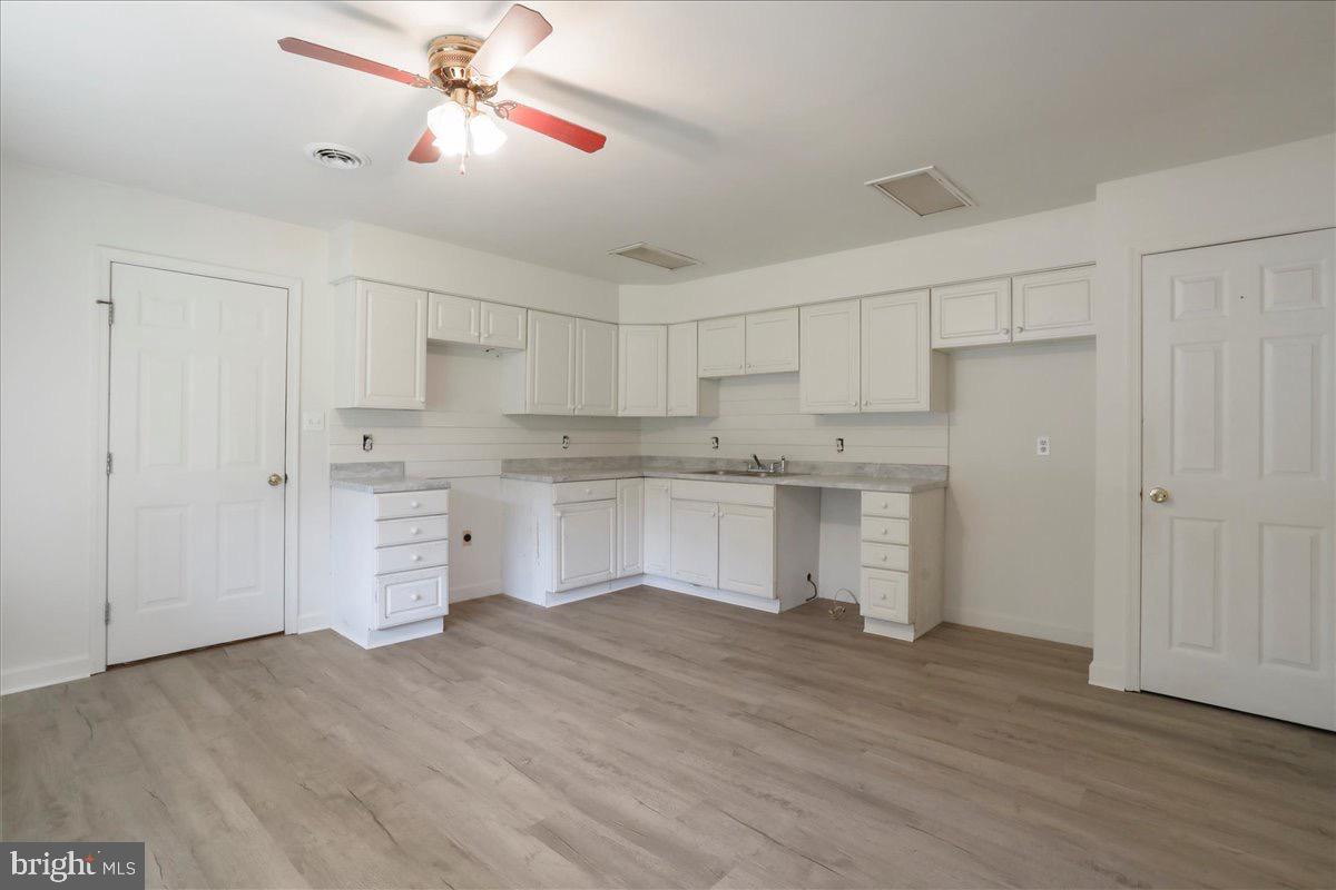 246 Poets Lane Inwood, WV 25428 - Photo 21 of 32 a kitchen with white cabinets and white appliances