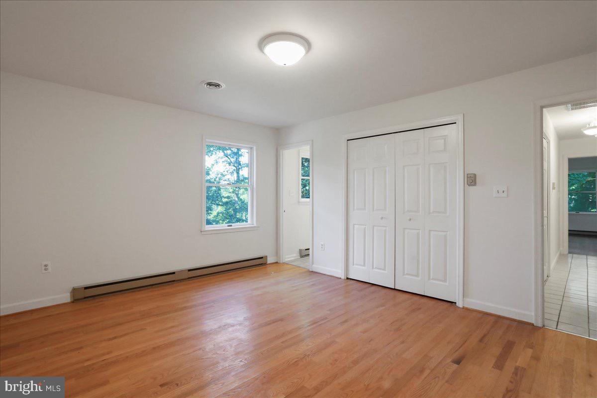 246 Poets Lane Inwood, WV 25428 - Photo 25 of 32 an empty room with wooden floor and windows