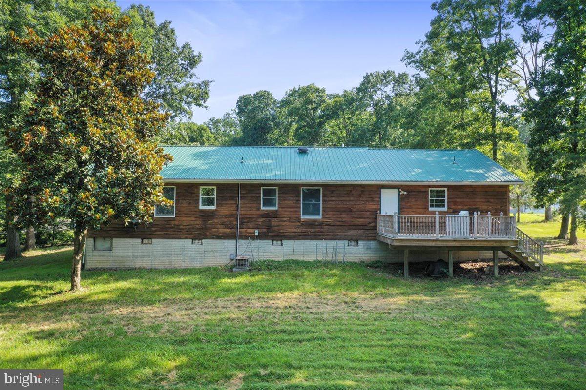 246 Poets Lane Inwood, WV 25428 - Photo 3 of 32 a front view of a house with a garden