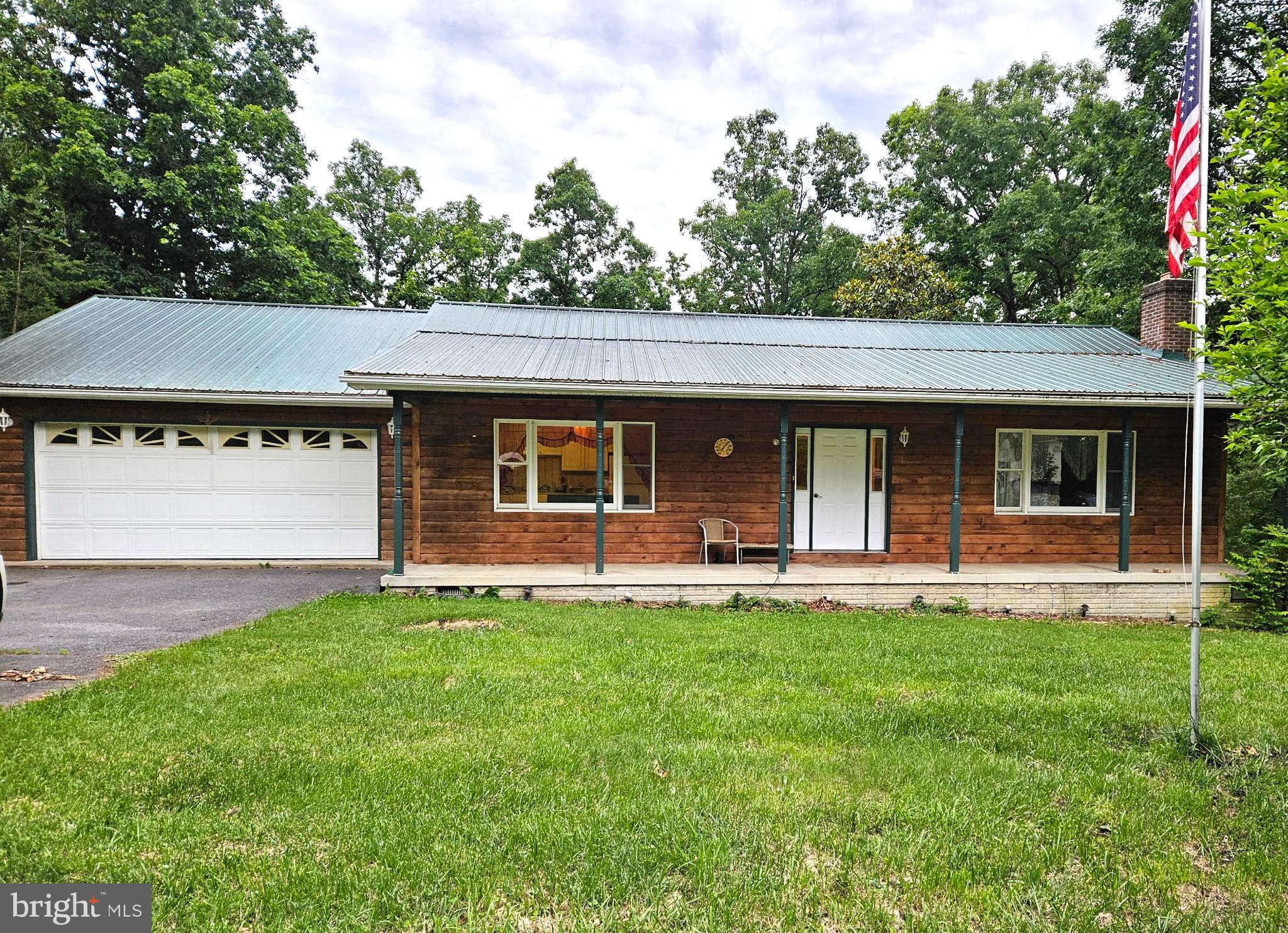 246 Poets Lane Inwood, WV 25428 - Photo 32 of 32 a front view of a house with a garden and porch