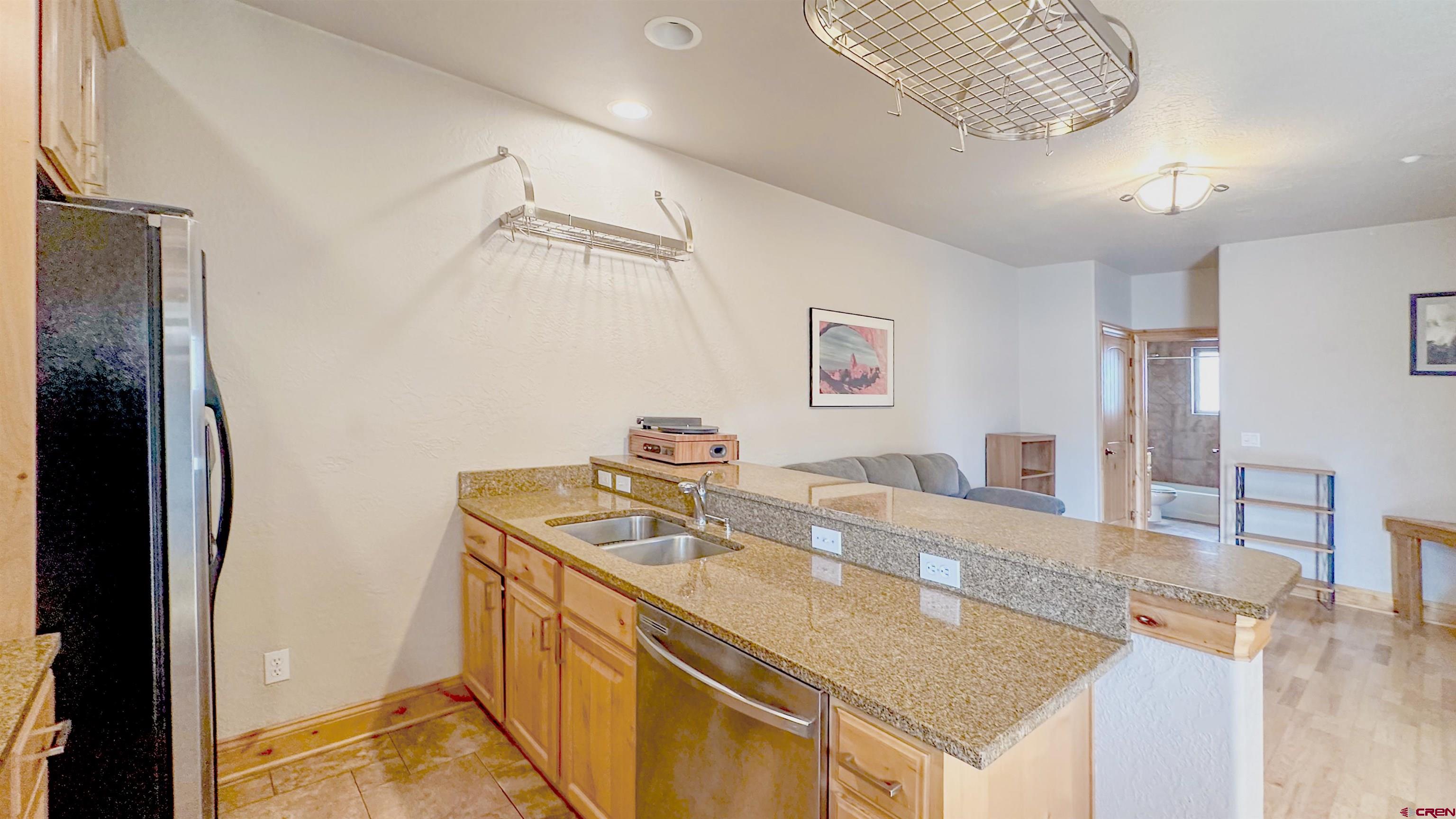 2855 Main Avenue, Unit A 209 Durango, CO 81301 - Photo 11 of 20 a kitchen with stainless steel appliances granite countertop a sink and a refrigerator