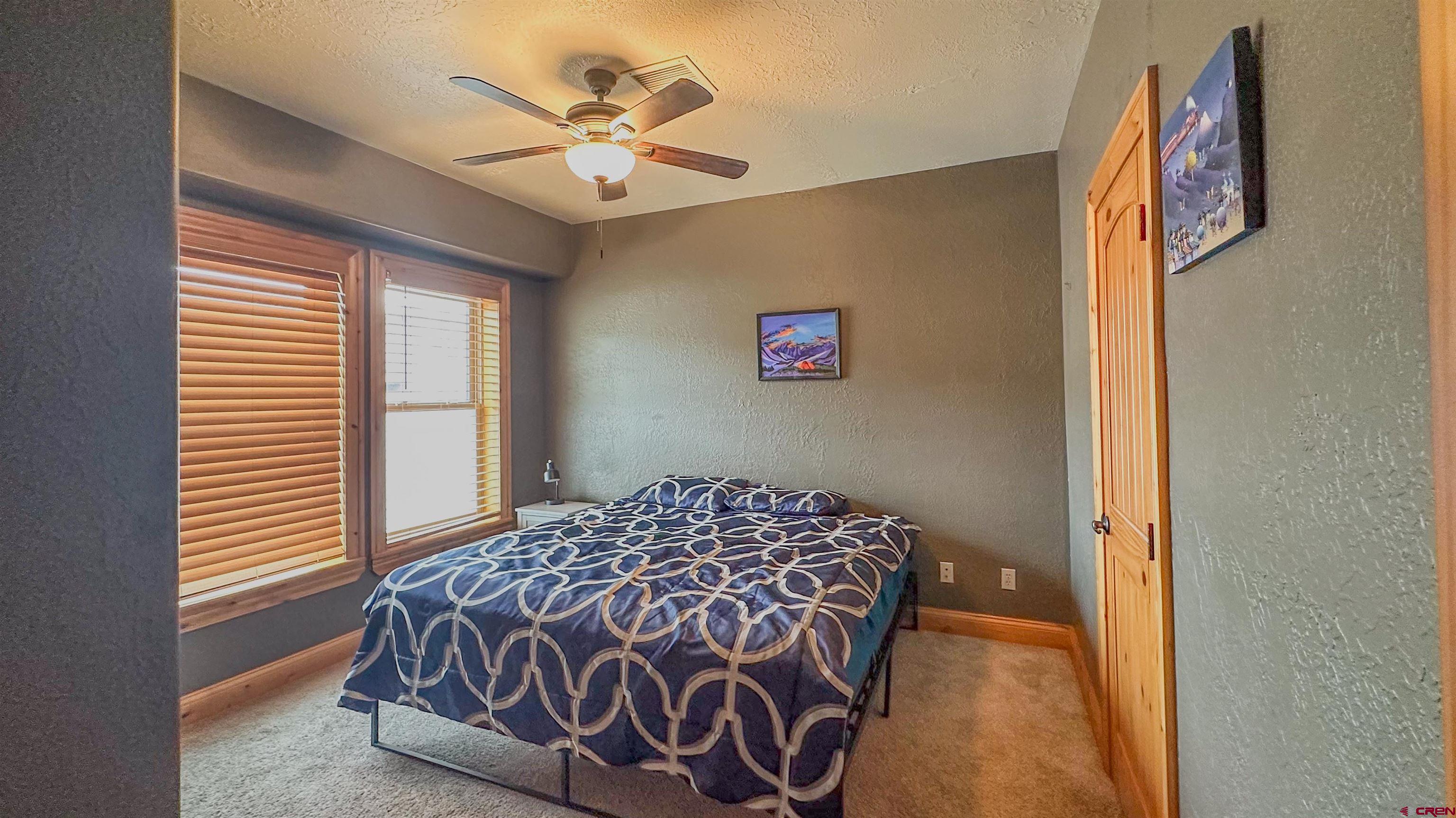 2855 Main Avenue, Unit A 209 Durango, CO 81301 - Photo 13 of 20 a bedroom with a bed and a chandelier