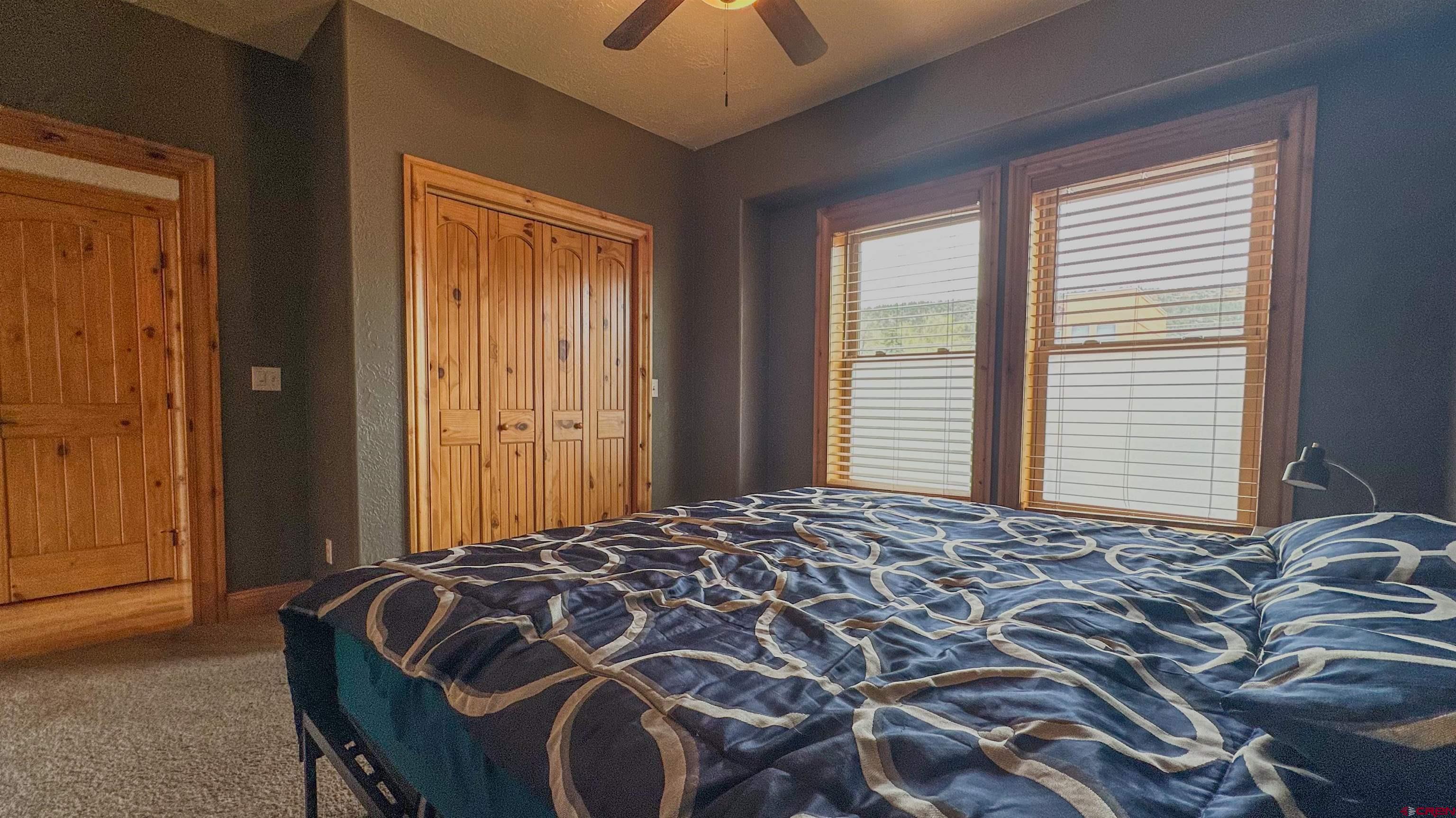 2855 Main Avenue, Unit A 209 Durango, CO 81301 - Photo 14 of 20 a bed sitting in a bedroom next to a window and a chandelier