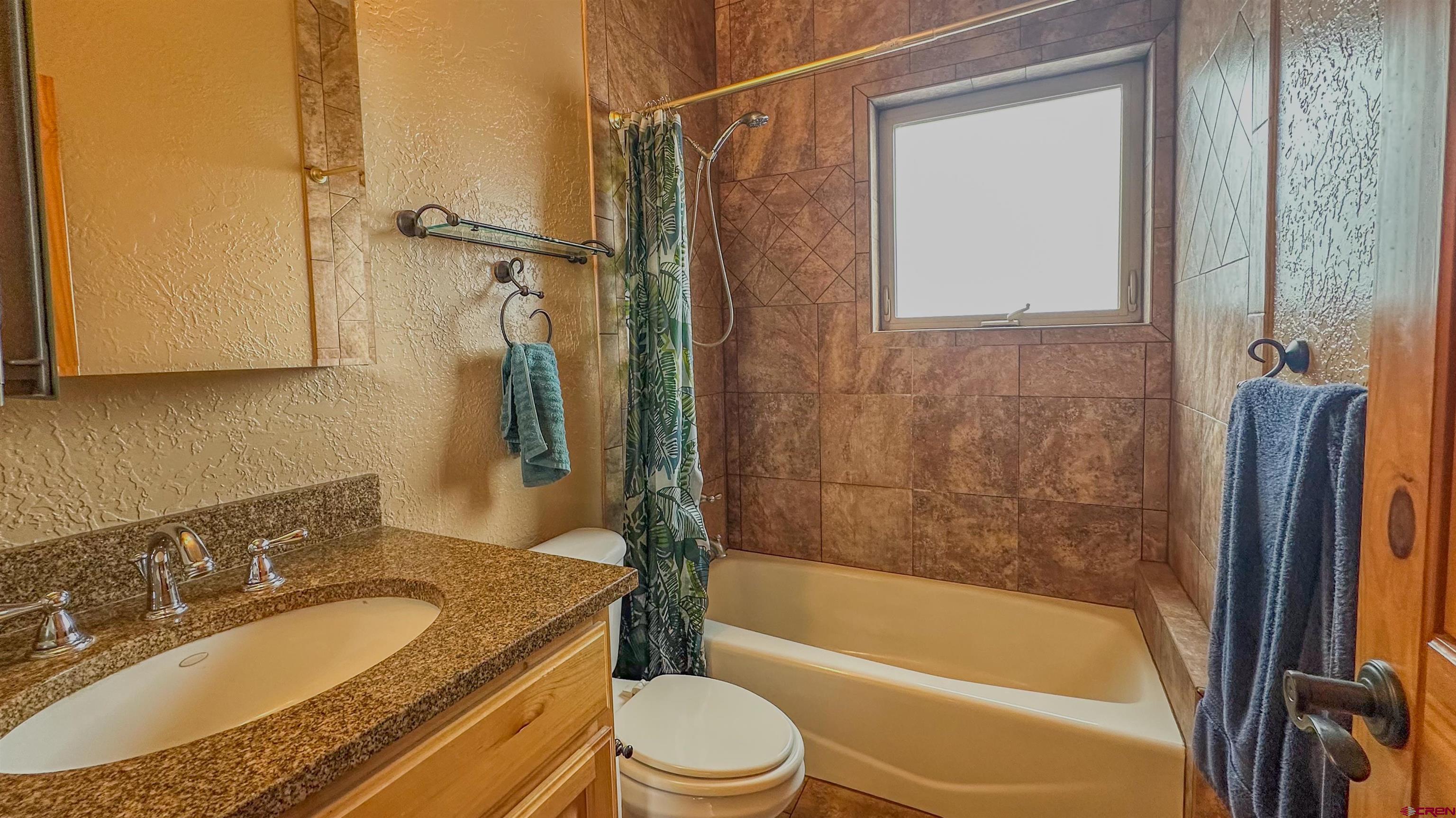 2855 Main Avenue, Unit A 209 Durango, CO 81301 - Photo 18 of 20 a bathroom with a granite countertop bathtub shower sink vanity and toilet