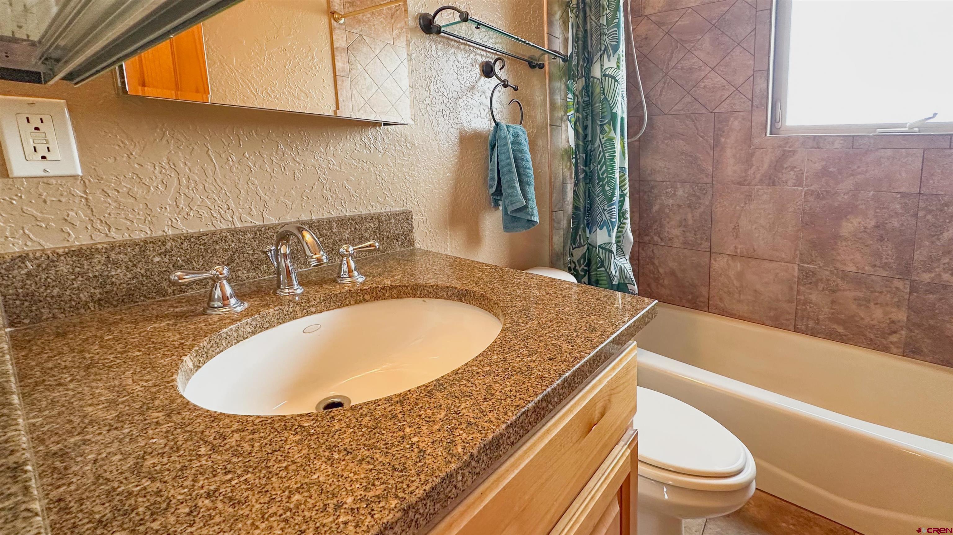 2855 Main Avenue, Unit A 209 Durango, CO 81301 - Photo 19 of 20 a bathroom with a granite countertop sink and a mirror