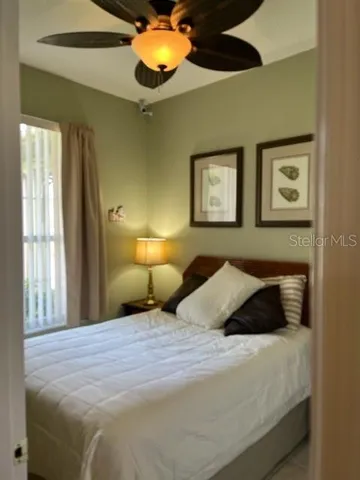 a bedroom with a bed and a window