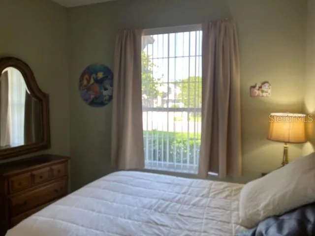 a bedroom with a bed and wall painting