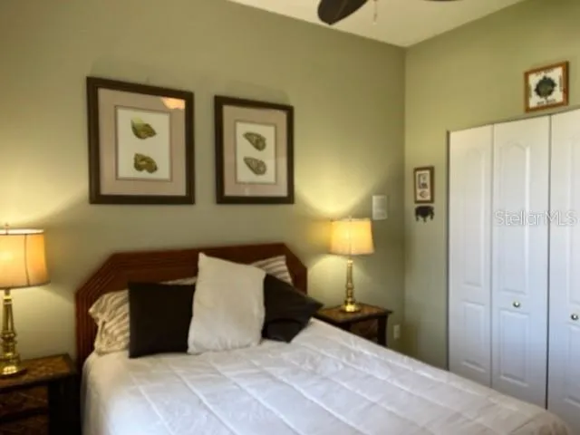 a bedroom with a bed and a lamp