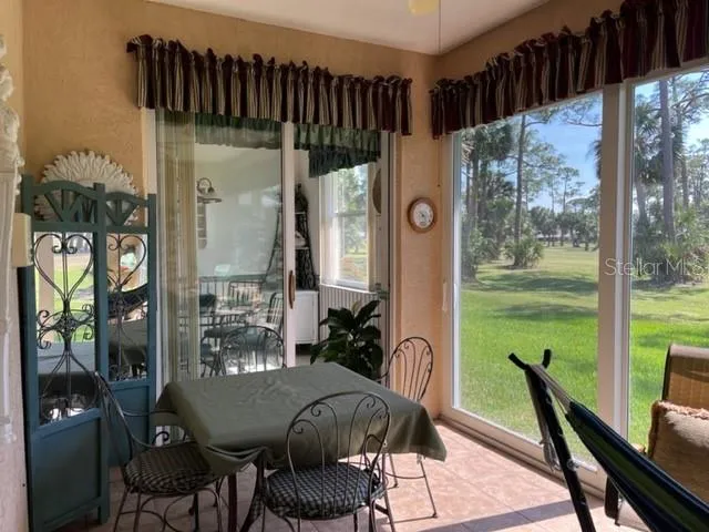 a view of a dining room with furniture window and outside view