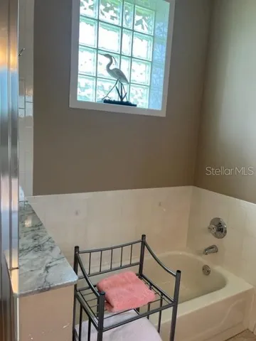 a bathroom with a sink mirror and a shower