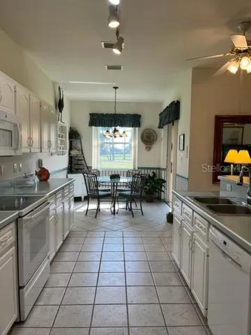 a view of a dining room with furniture wooden floor and a chandelier